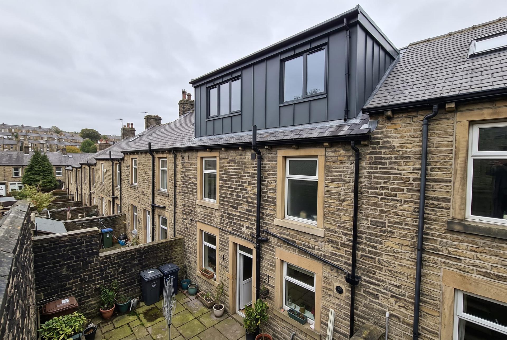 Full width rear dormer on a stone terrace