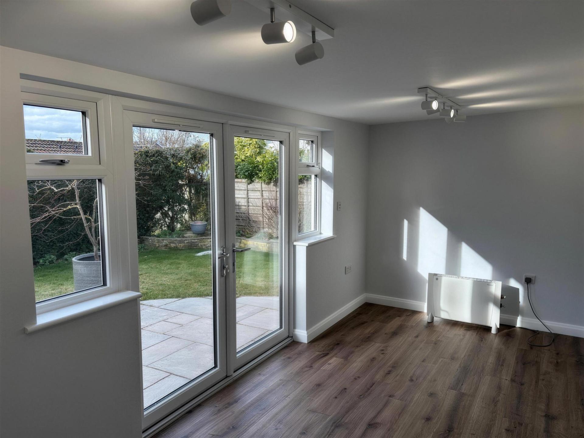 Finished home office interior with French doors onto the garden