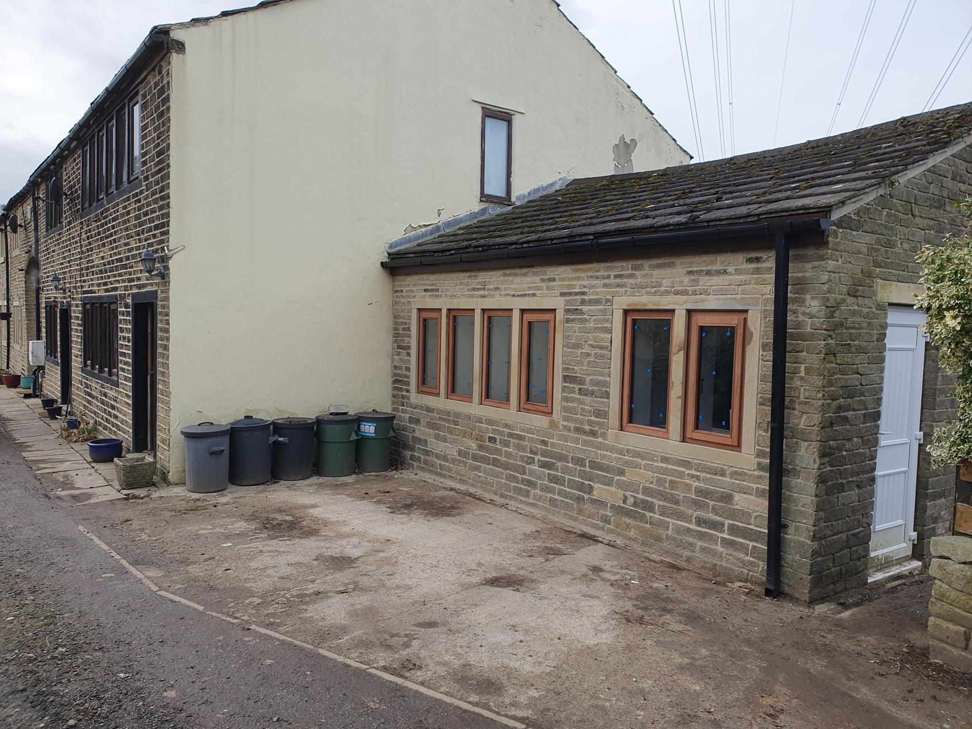 The stone garage during works, from the drive