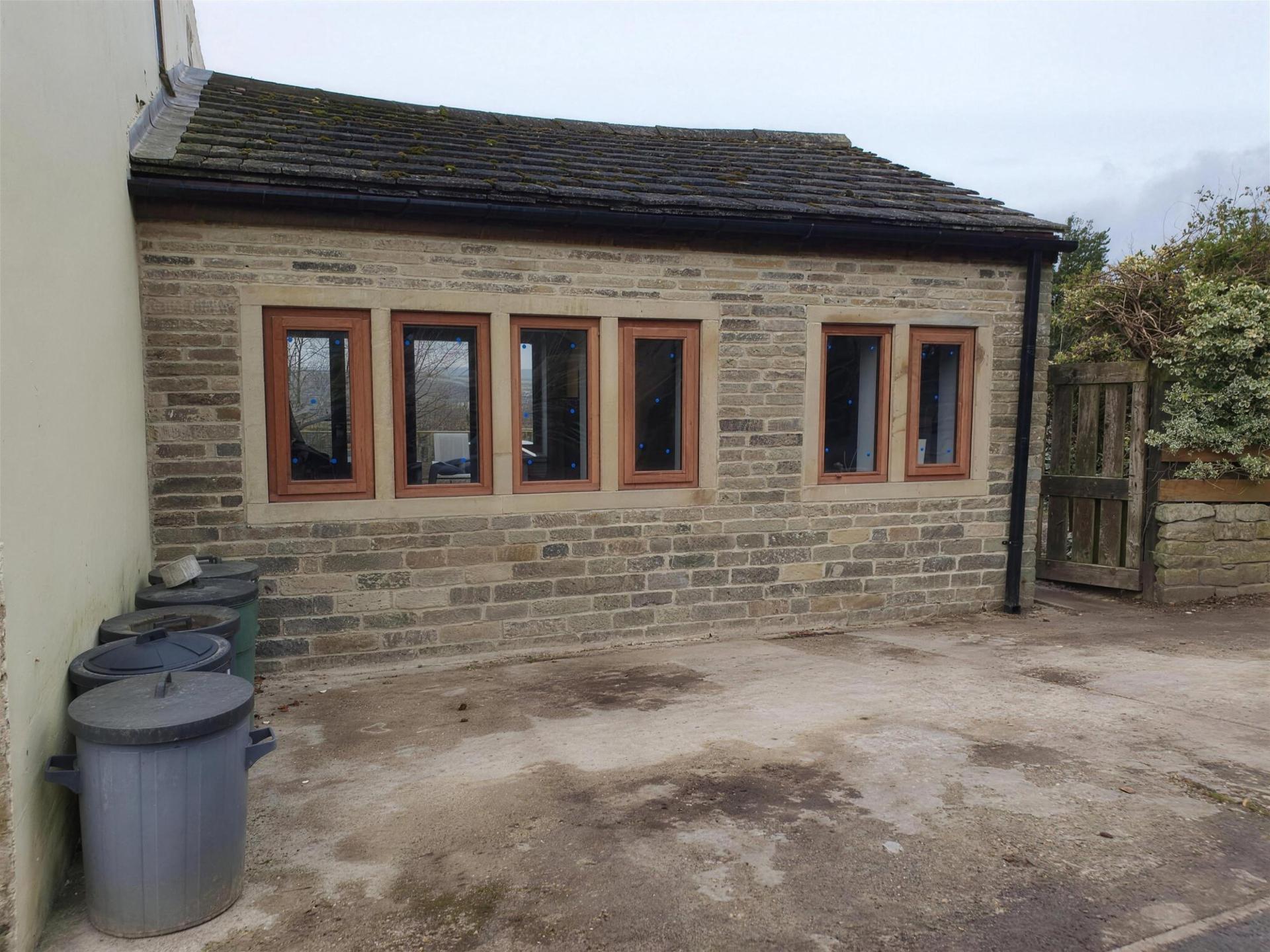 The finished stone garage with new windows